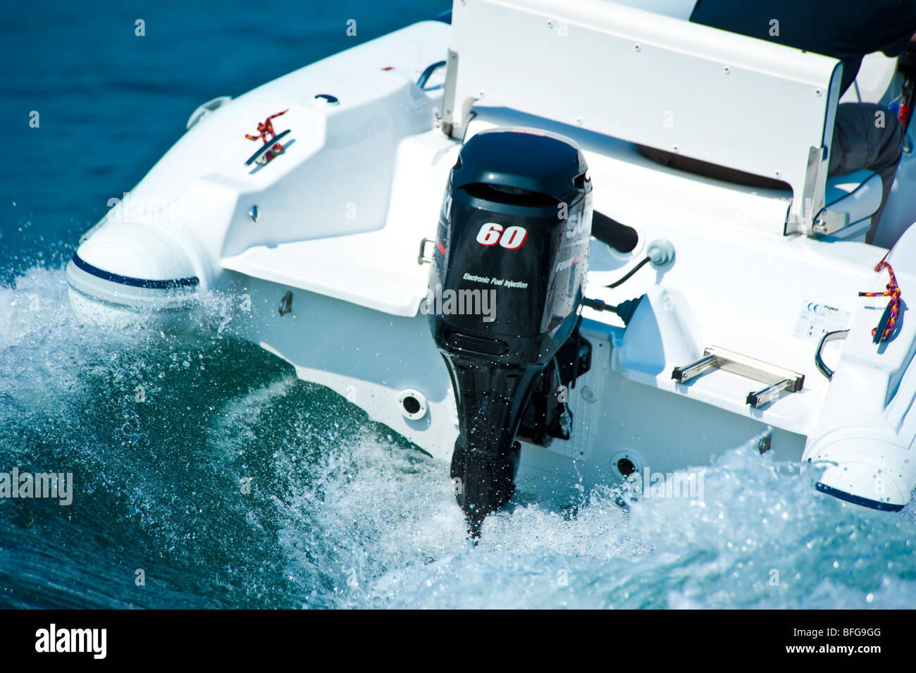 New 2009 model of Suzuki DF 60 outboard engine on power boat transom - Stock Image