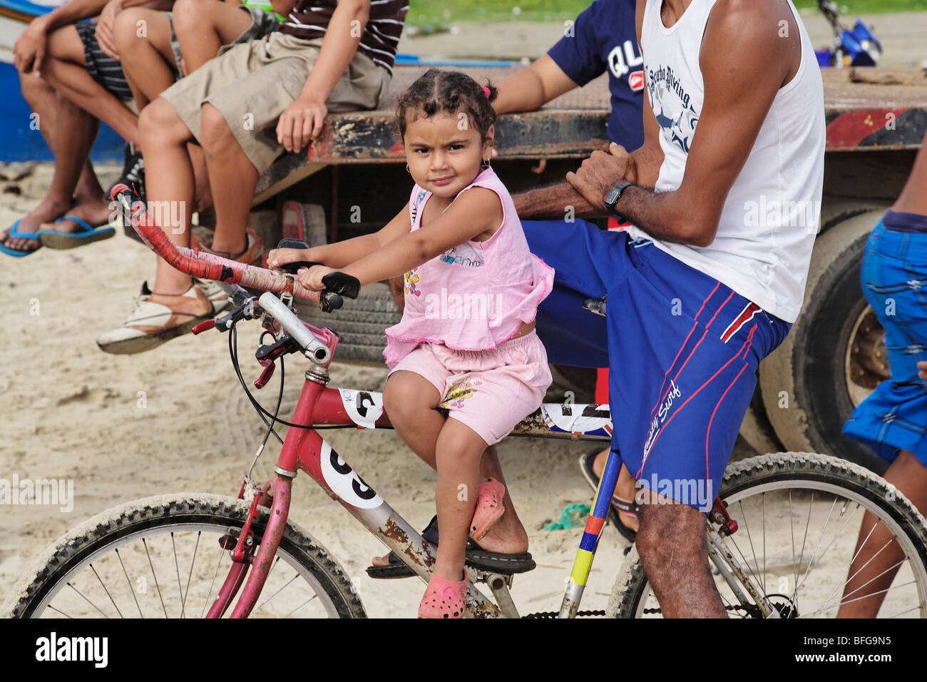 Girl sitting on a bicycle, Playa El Tirano, Isla de Margarita, Nueva ...