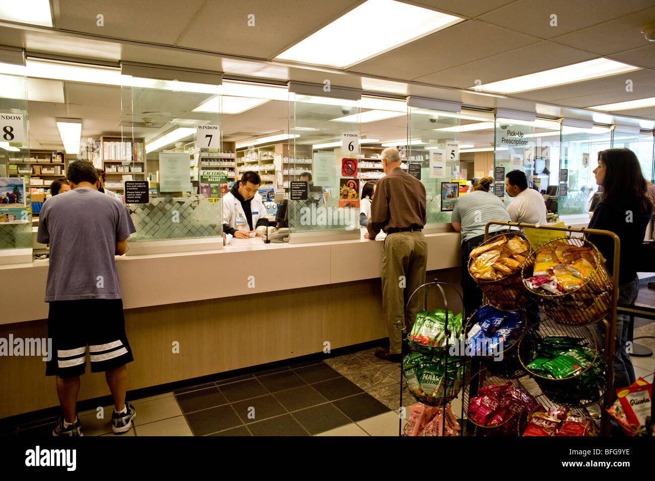 Customers pick up prescriptions at the pharmacy of a health maintenance