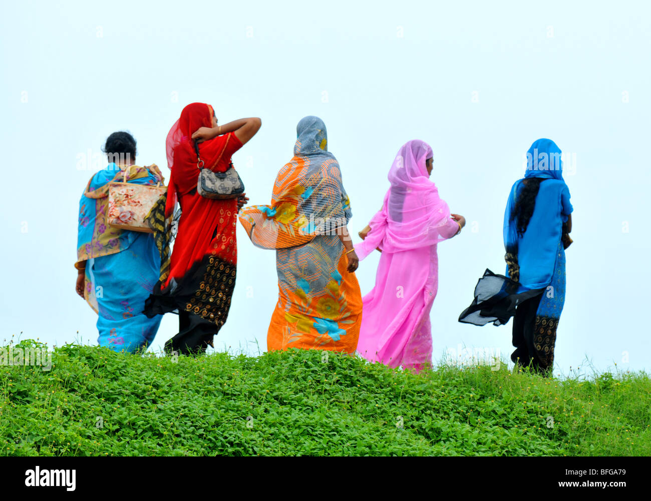 Sri Lankan women dressing in traditional saris, five women dressed in sarees walk together in Sri Lanka Stock Photo