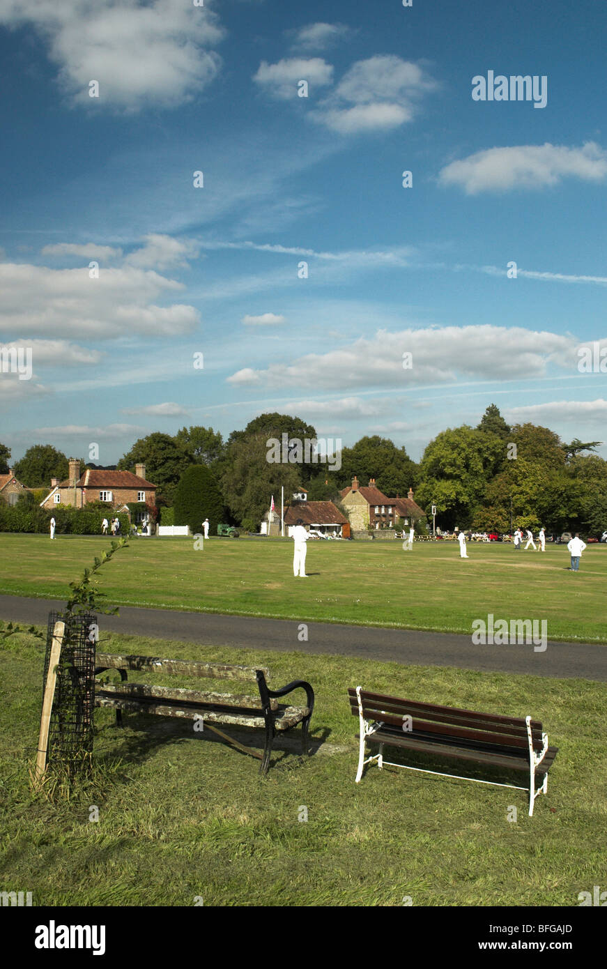 A quintessential English village green complete with a cricket match in play. Stock Photo