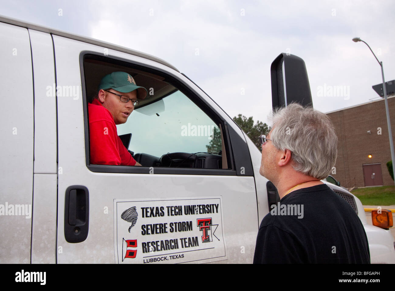 Dr. Josh Wurman speaks with a colleague in eastern, Nebraska, USA, June ...