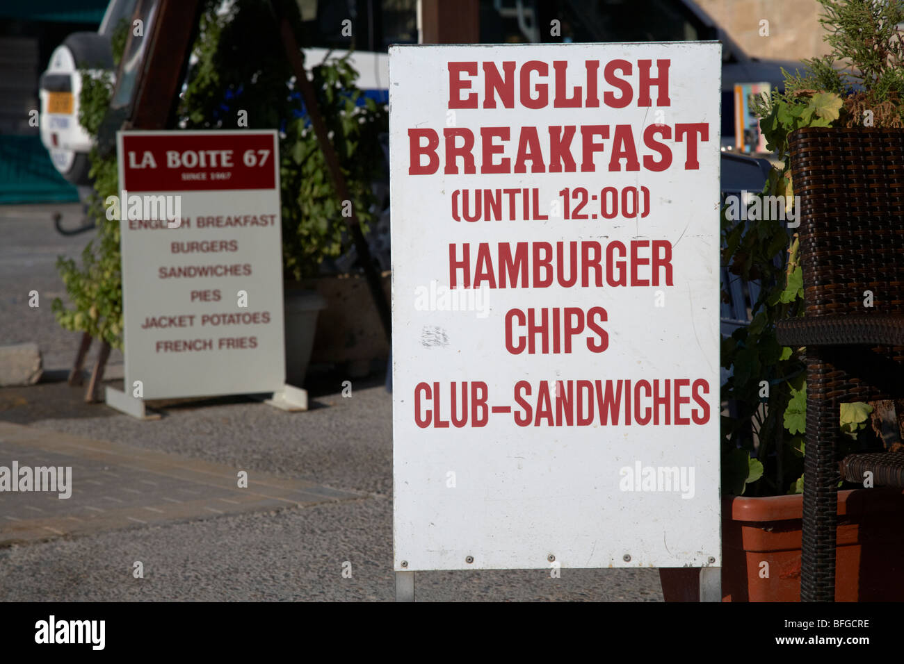 sign advertising english breakfast hamburger chips and club sandwiches