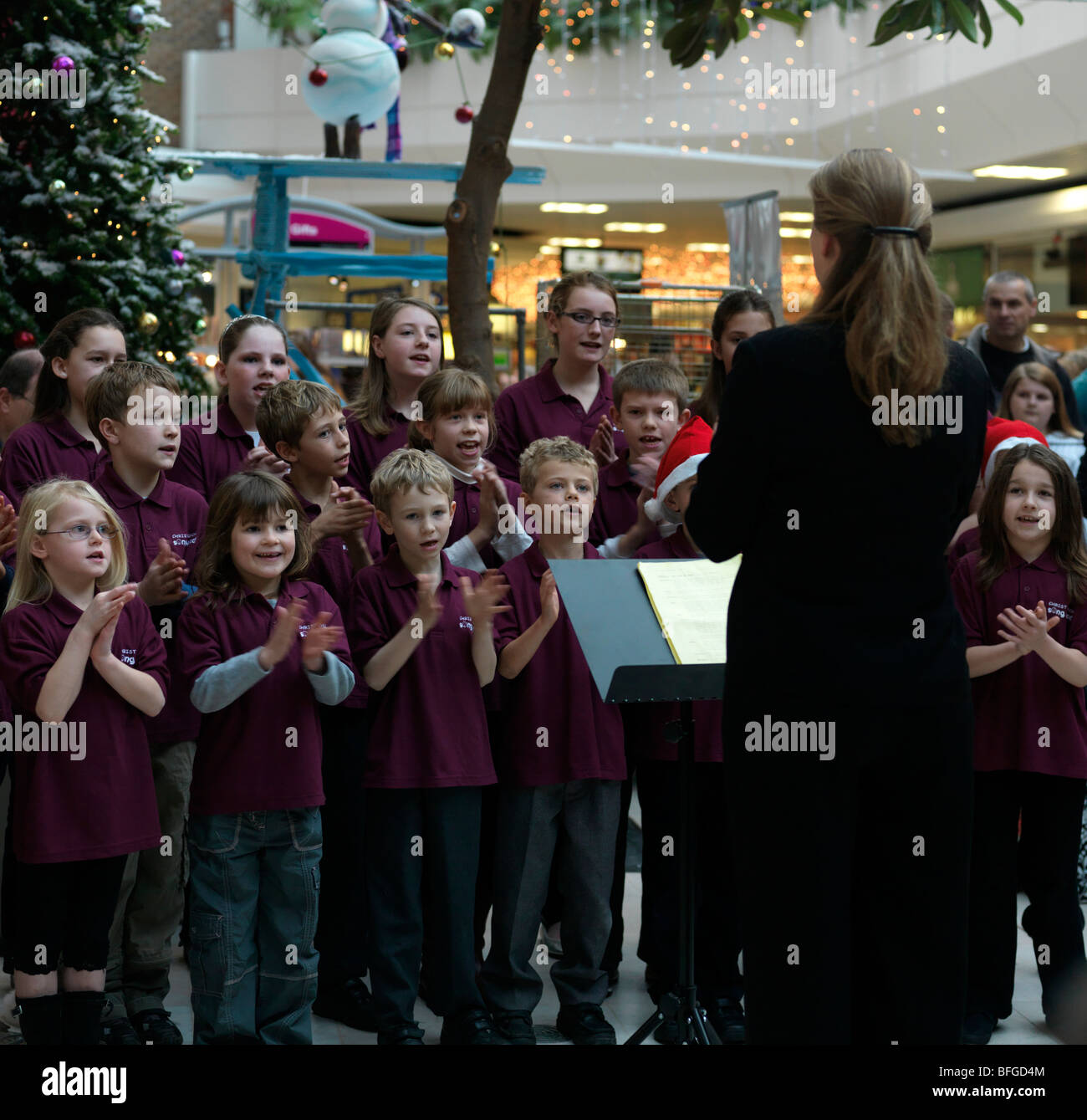 Children's Choir Singing Christmas Carols in the Town Centre Epsom Surrey Stock Photo