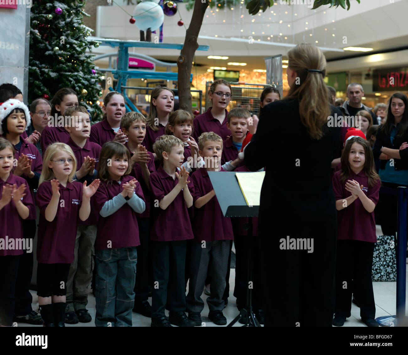 Children's Choir Singing Christmas Carols in the Town Centre Epsom Surrey Stock Photo