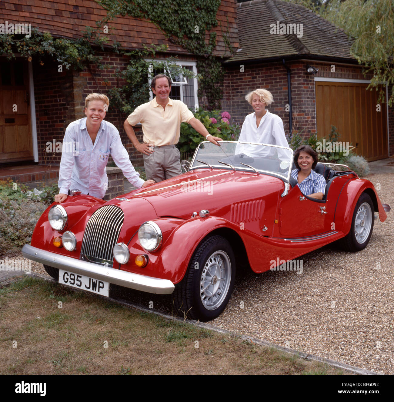 BBC TV newsman Michael Buerk with his family and beloved Morgan sportscar Stock Photo