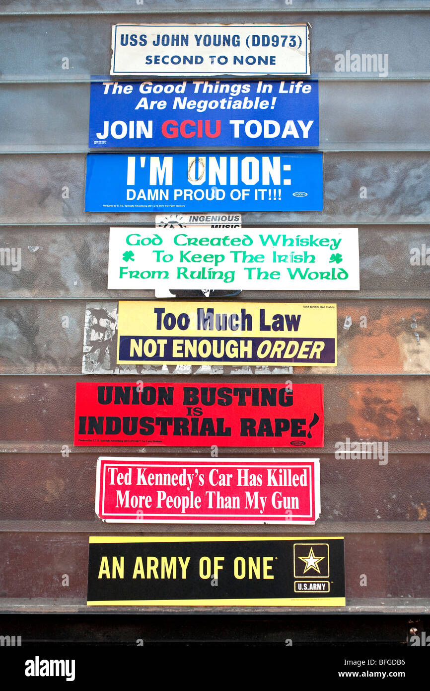a group of conservative pro union patriotic slogans mounted on the glass jalousie panels of a front door in Red Hook Brooklyn Stock Photo