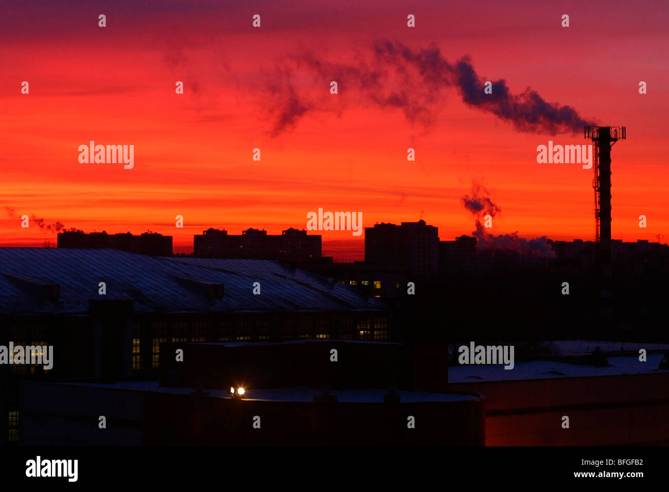 Red sunset over industrial city skyline with smoking chimney Stock ...