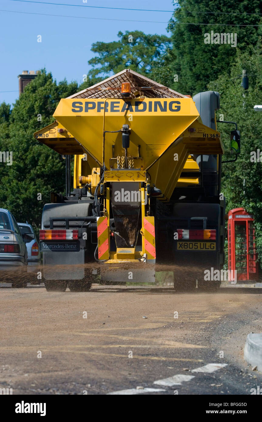 Gritters normally used to salt roads now put sand down onto tar on roads melting in the heatwave Stock Photo