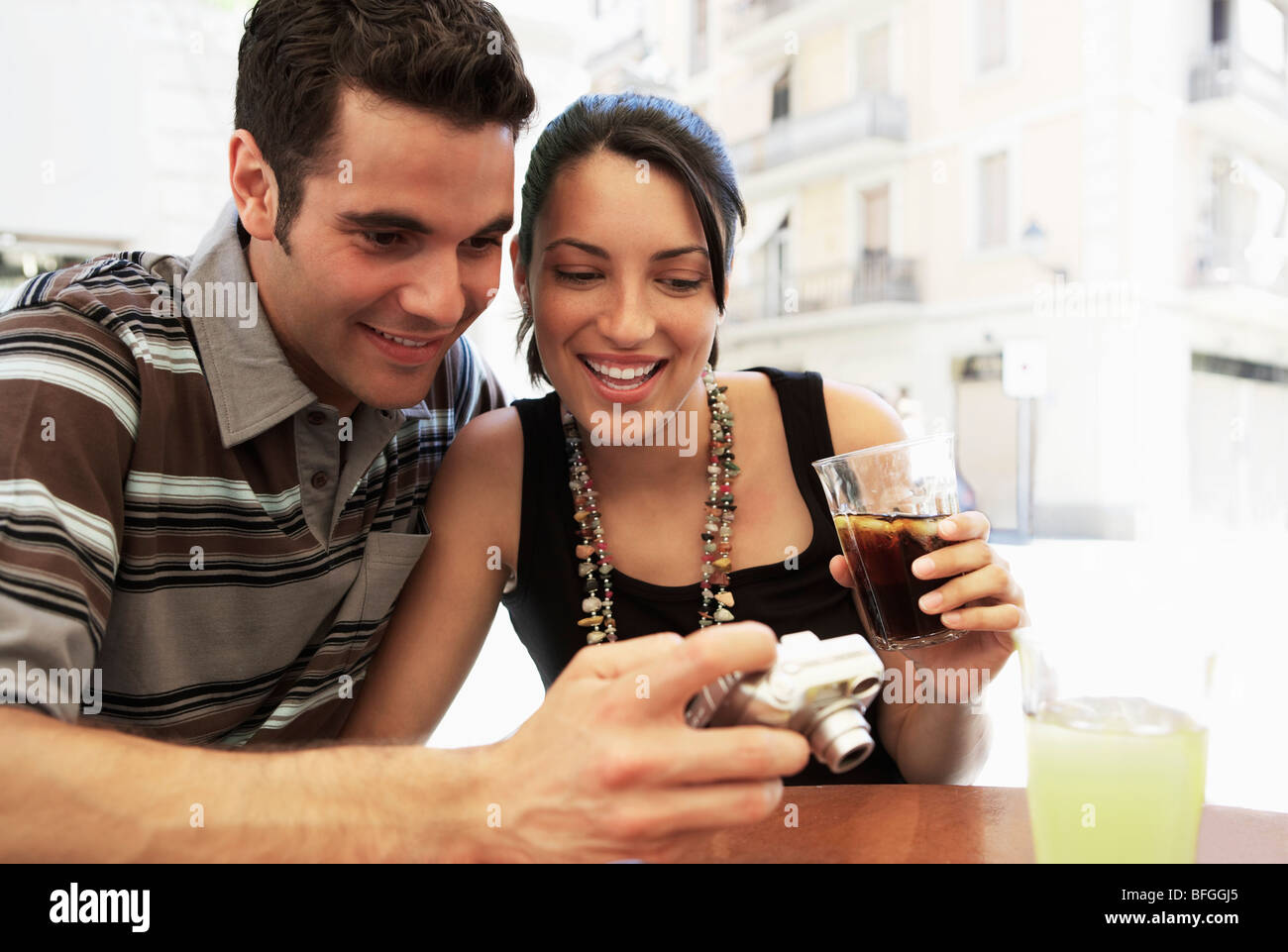 Young couple at cafe looking at camera together, portrait Stock Photo