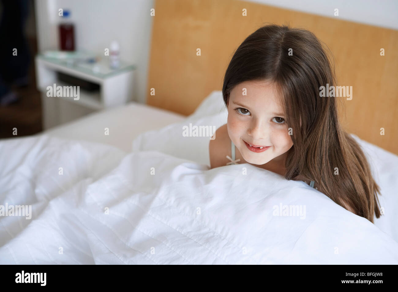 Little girl sitting up in bed, portrait Stock Photo Alamy