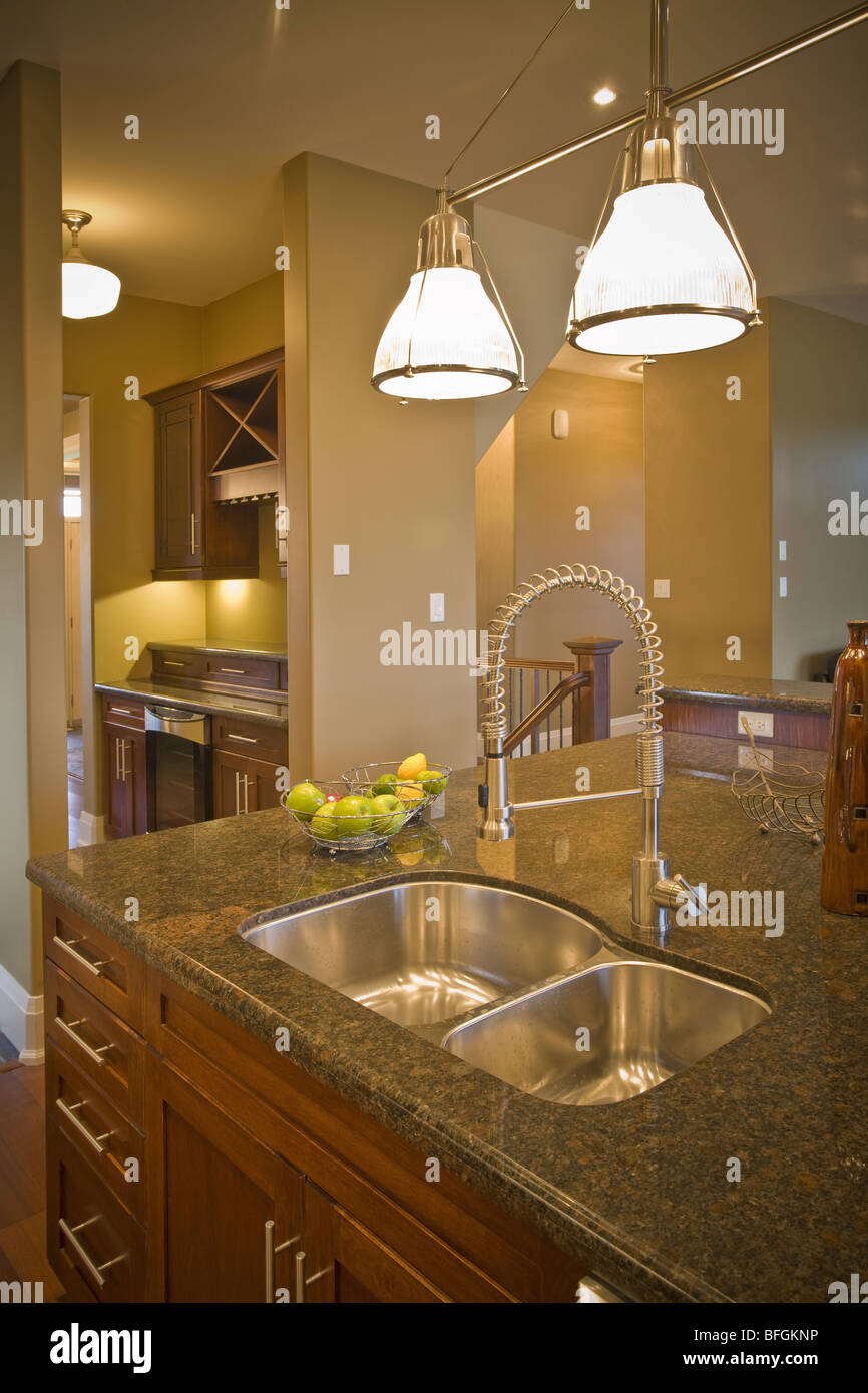 Kitchen sink with pantry in background Stock Photo