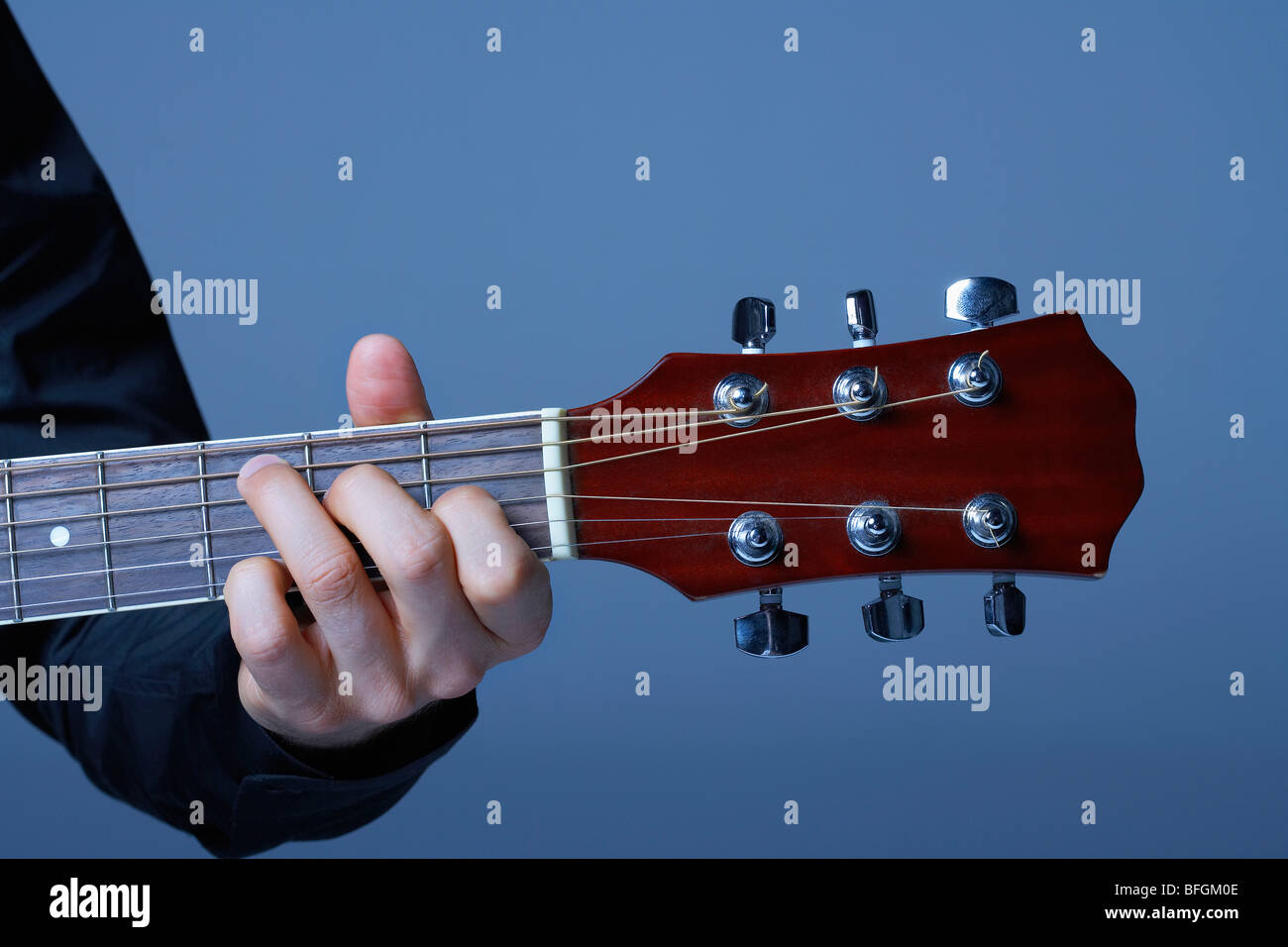 Hand Playing on Neck of Guitar, detail, close-up Stock Photo