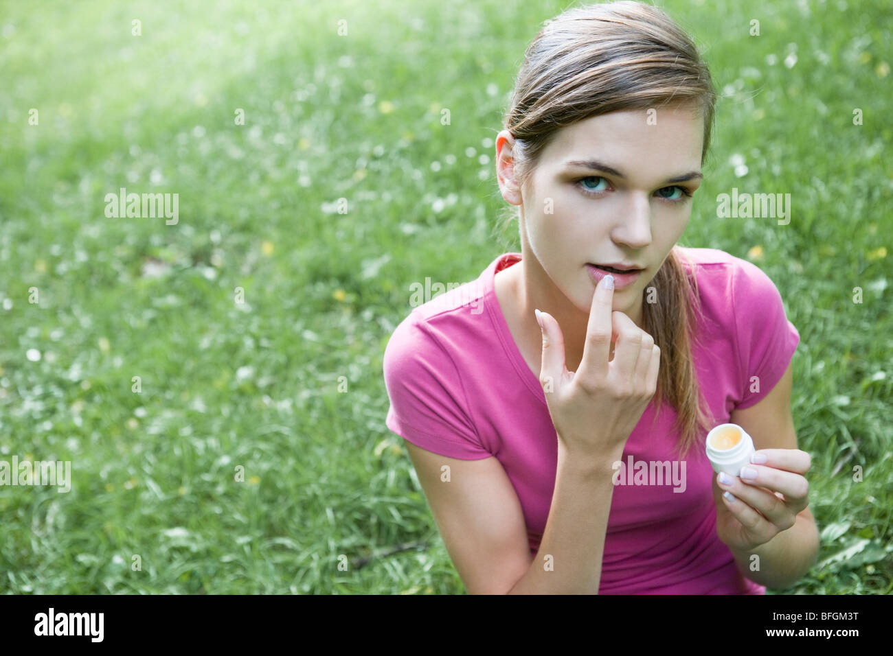 woman applying lip balm Stock Photo