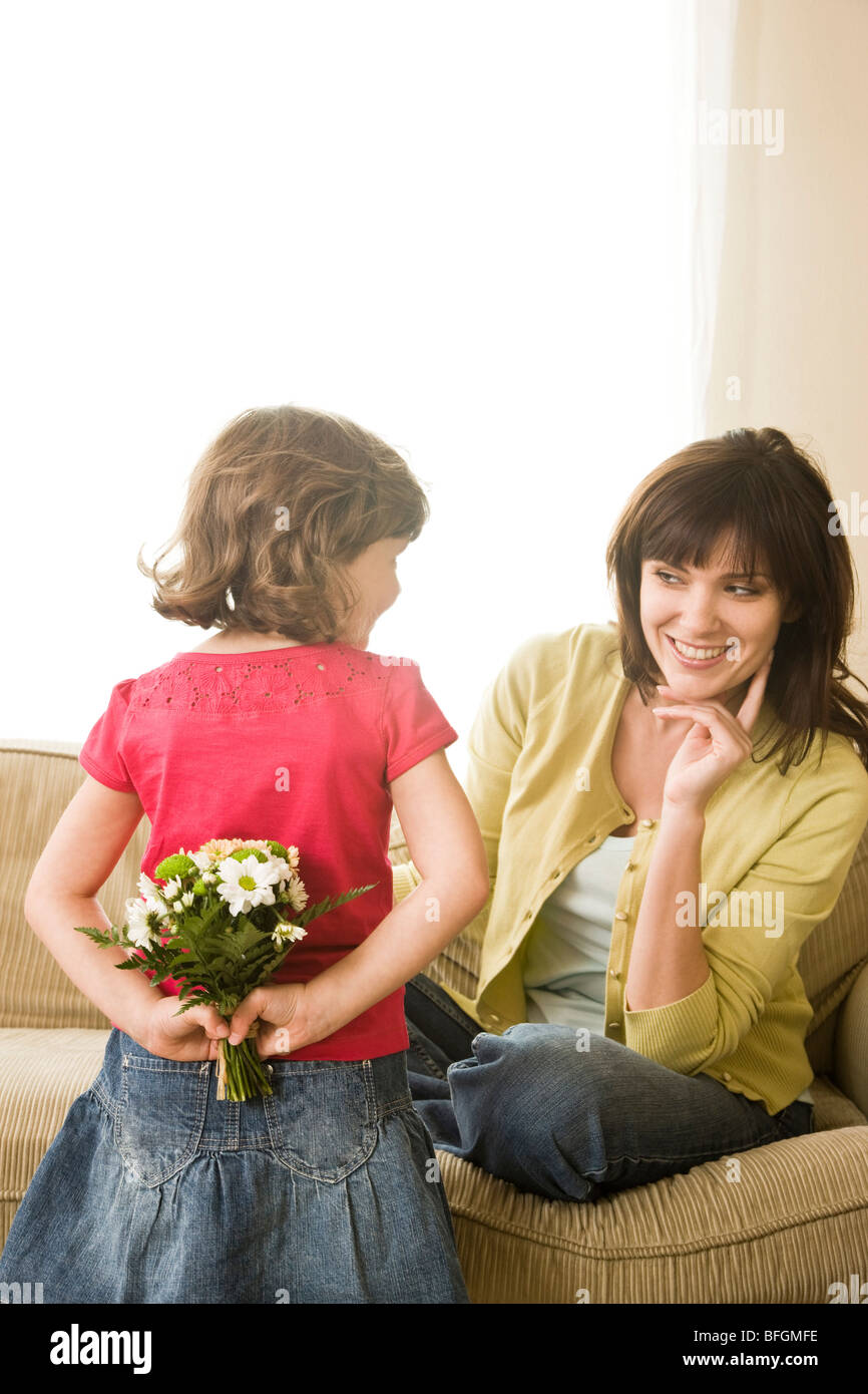 daughter giving mother flowers Stock Photo Alamy