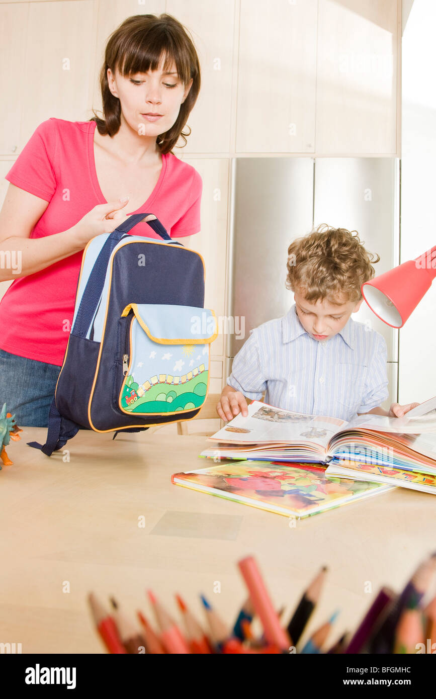 mother checking schoolbag weight Stock Photo