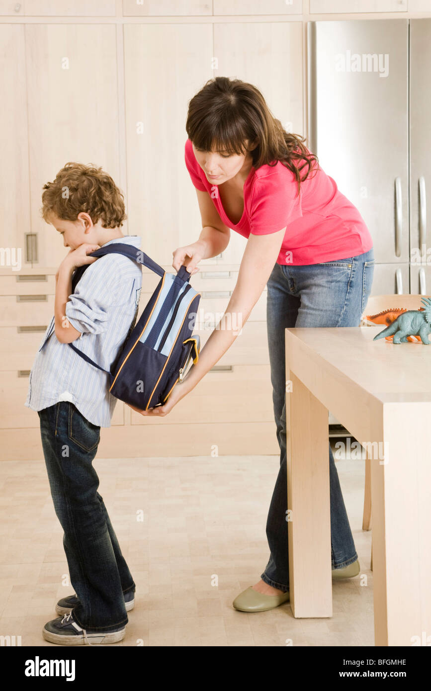 mother checking schoolbag weight Stock Photo