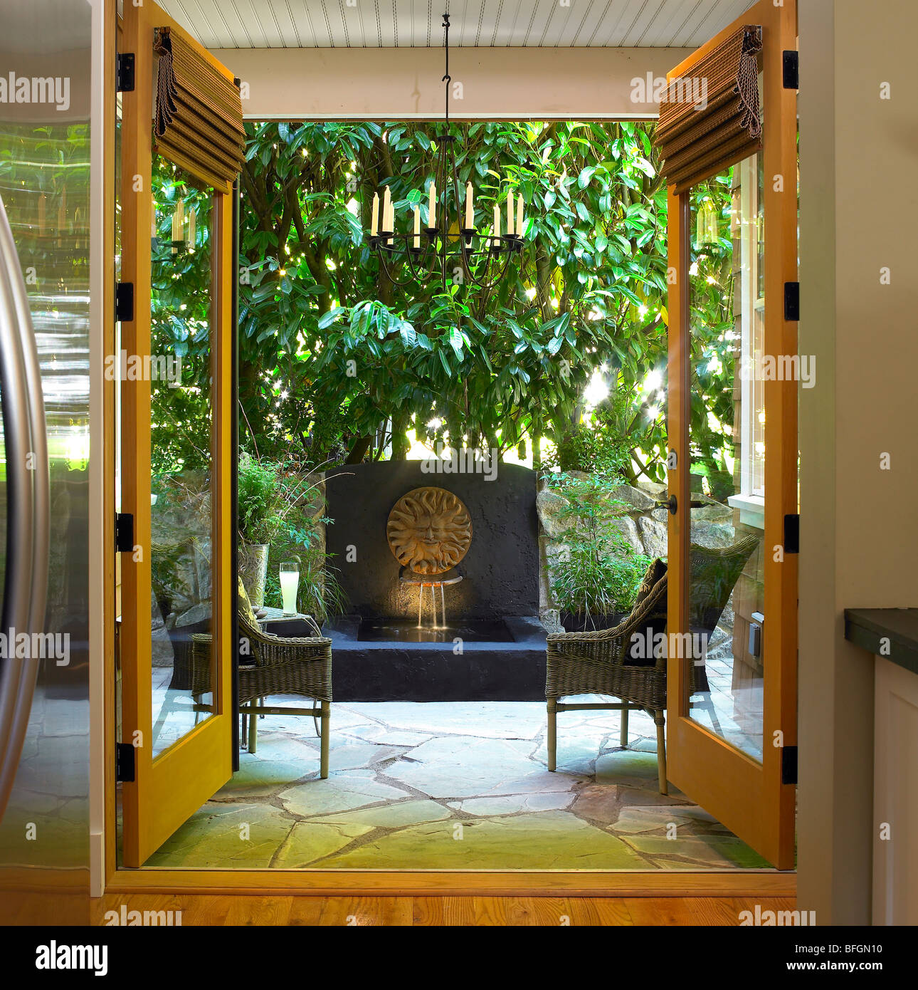 View Of Garden Patio And Sun Fountain Through Open French