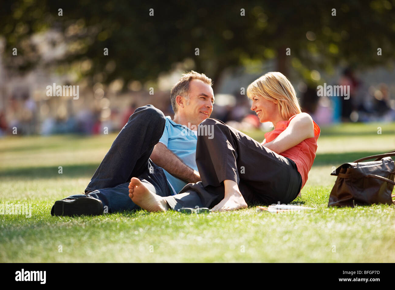 Middleaged couple reclining in park, surface view Stock Photo Alamy