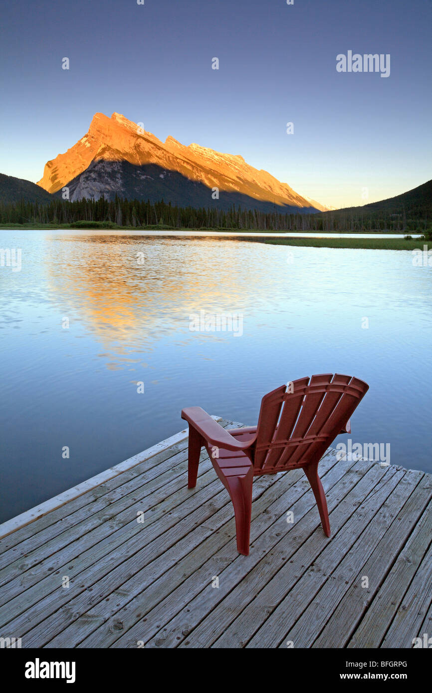 Chair on jetty at Vermillion Lake with Mount Rundle in background. Banff National Park, Alberta, Canada. Stock Photo