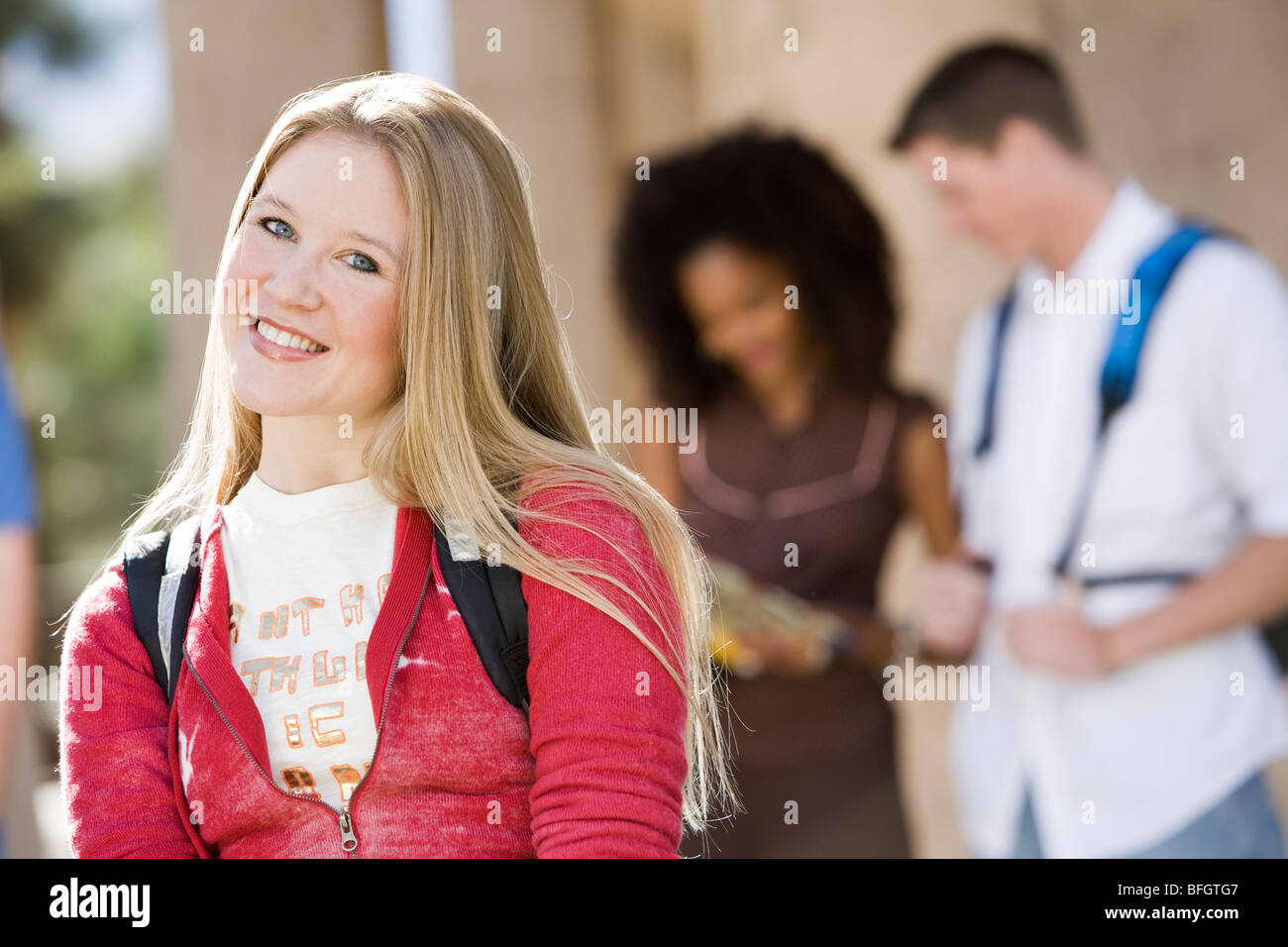 Young female student smiling at camera Stock Photo - Alamy