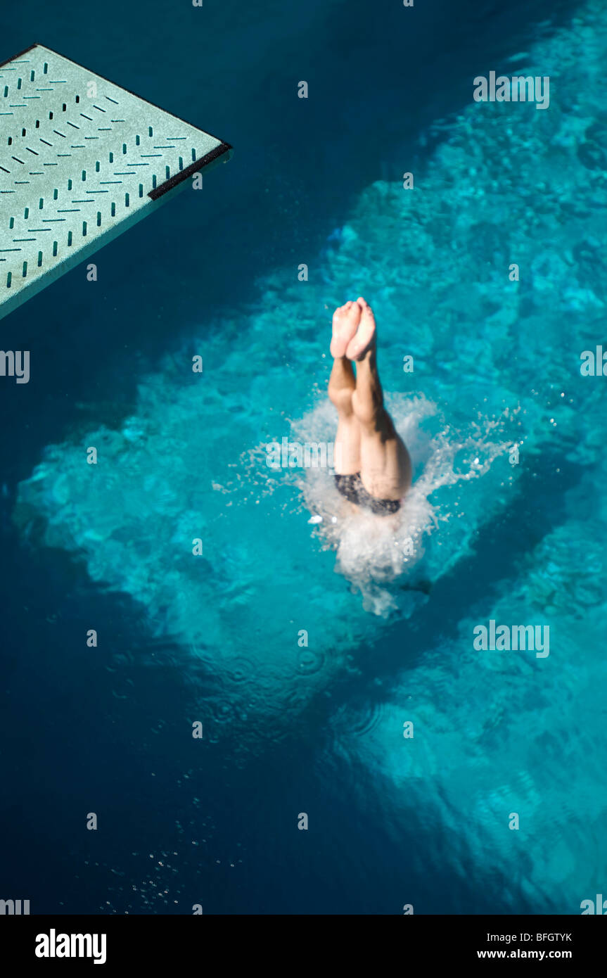 Swimmer diving into swimming pool Stock Photo