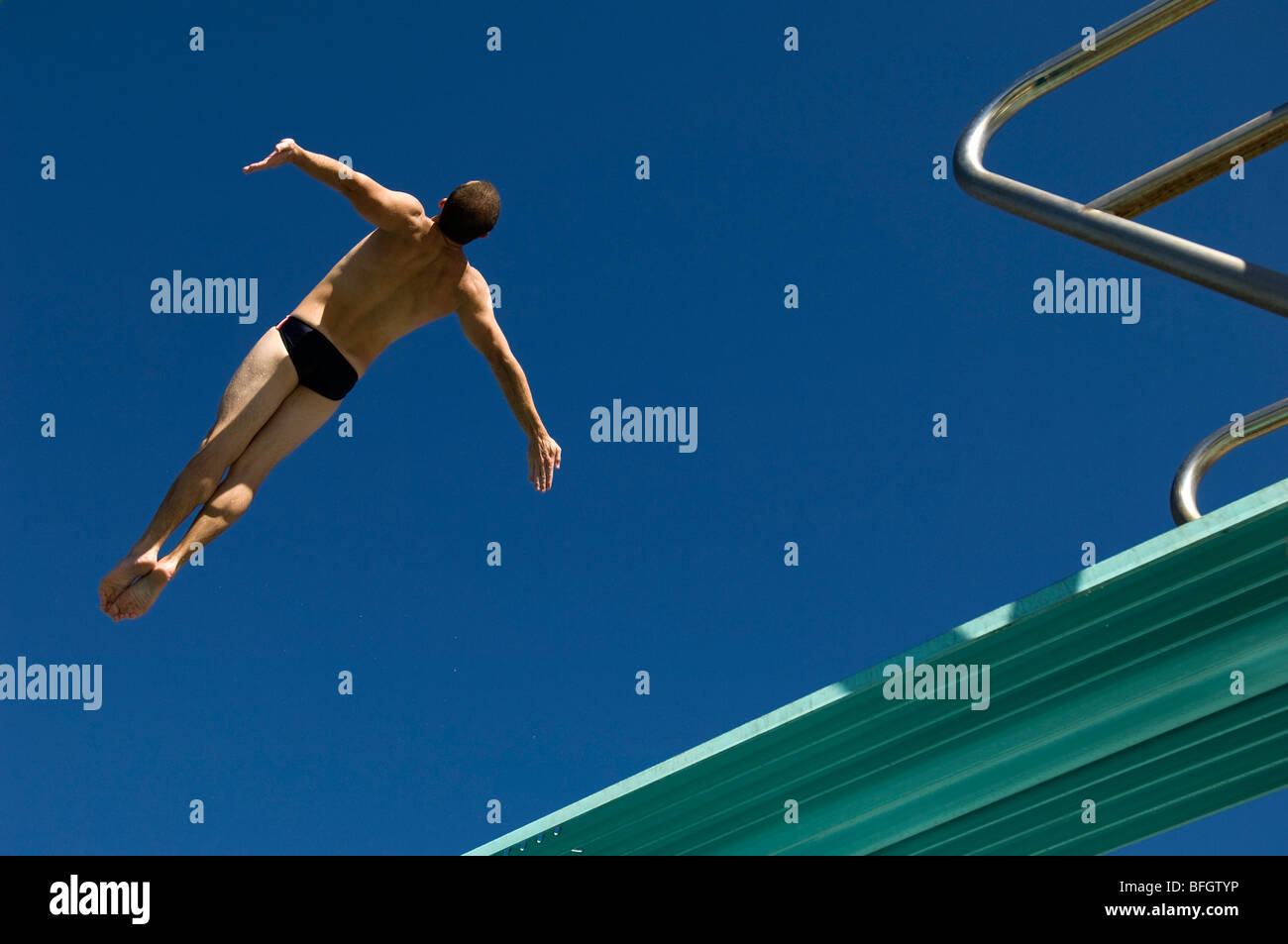 Swimmer diving into swimming pool Stock Photo - Alamy