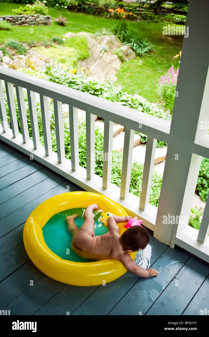 feet of a one year and a half baby boy on a green blanket Stock Photo