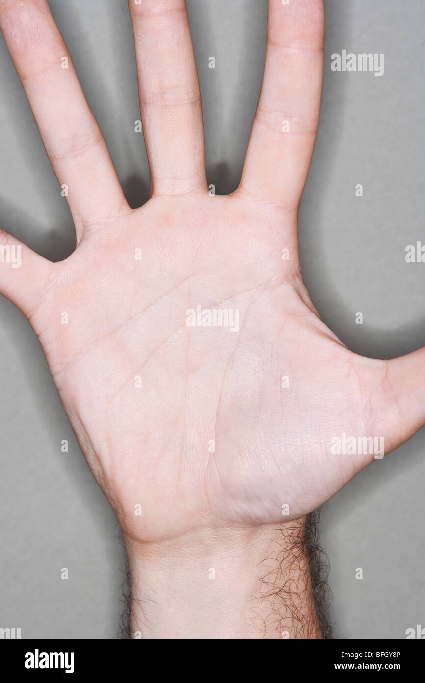 Man displaying outstretched hand, close-up on palm of hand Stock Photo