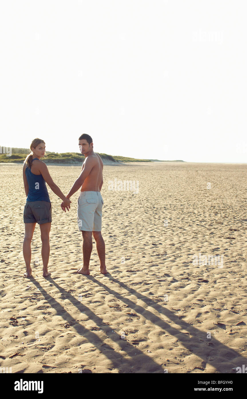 Two women holding hands beach hi-res stock photography and images - Alamy