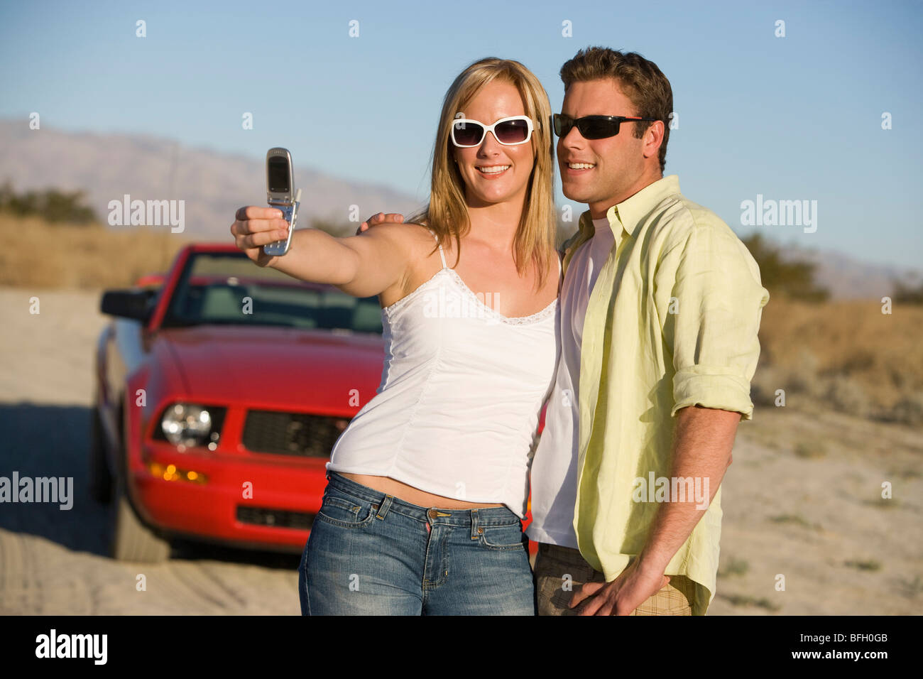 Couple Taking a Camera Phone Picture Stock Photo