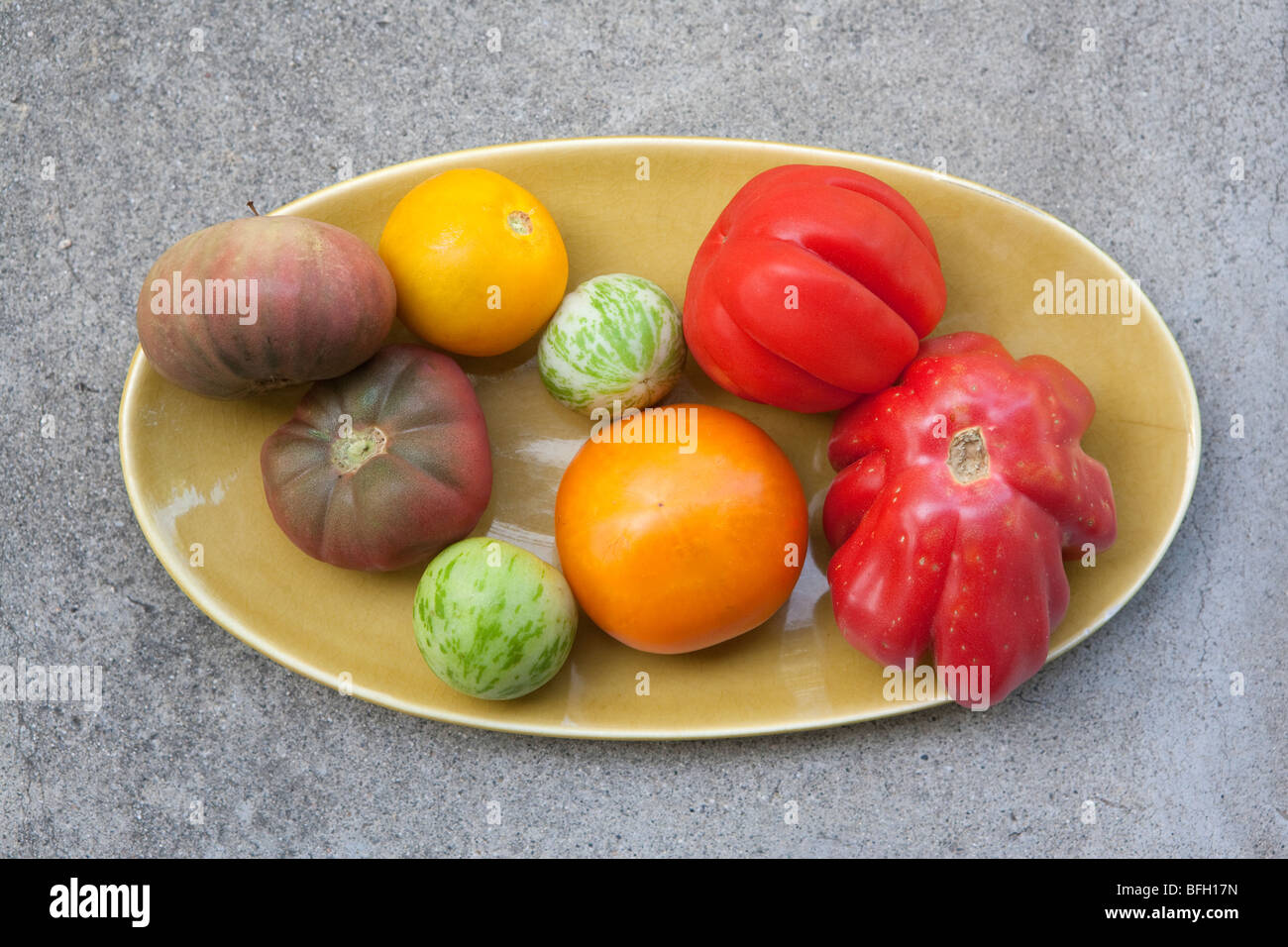 Heirloom tomatoes on Russel Wright oval plate Stock Photo