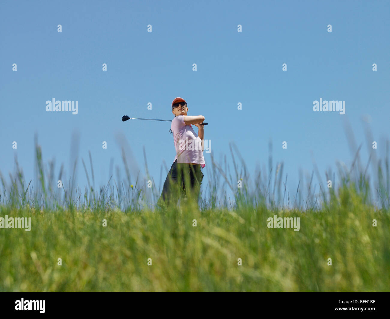 Female golfer driving golf ball hires stock photography and images Alamy