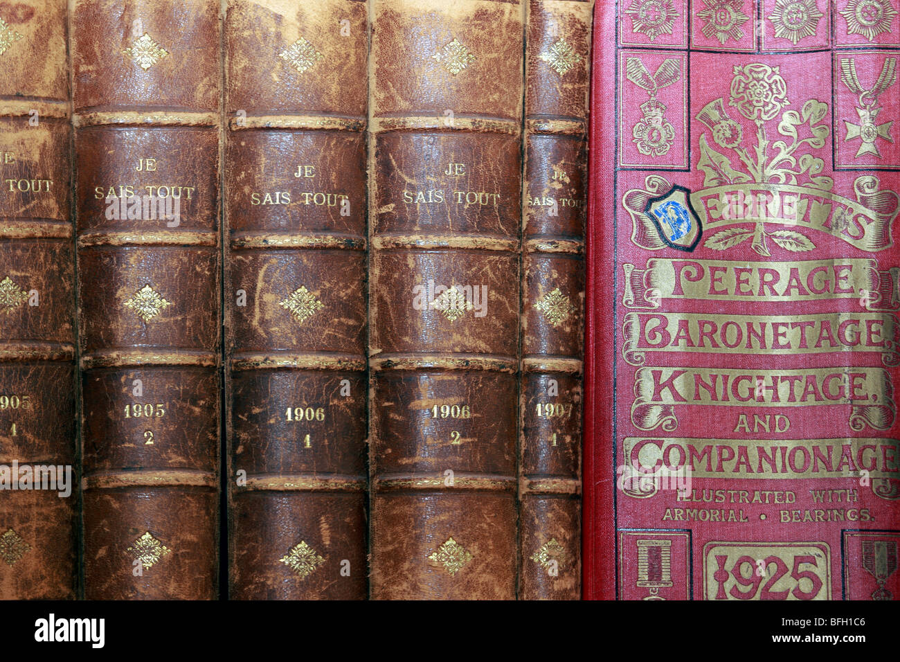 Old books including Debrett's Peerage Baronetage Knightage 1925 on a book shelf Stock Photo