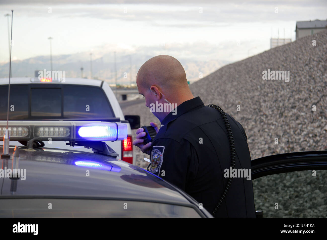 Nevada Highway Patrol State Trooper speaking on the radio after stopping a  vehicle for a traffic offence Stock Photo - Alamy