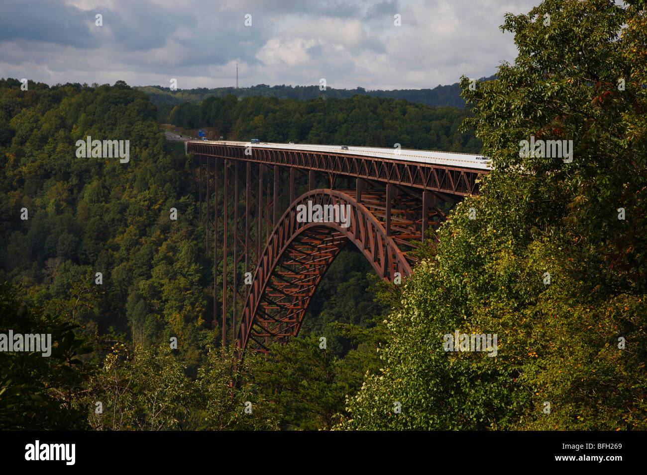 New River Gorge Bridge in West Virginia USA landscape nobody outside horizon water blue sky horizontal forest woods Autumn leaves cloudscape hi-res Stock Photo