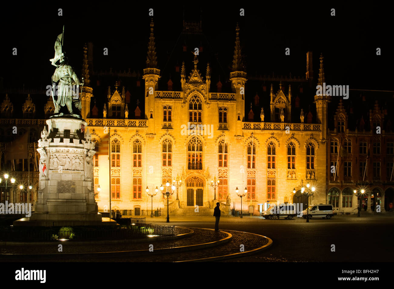 Evening view of the statue of Breidel and Pieter de Coninck and the Provincial Court in Markt Square, Bruges, Belgium. Stock Photo