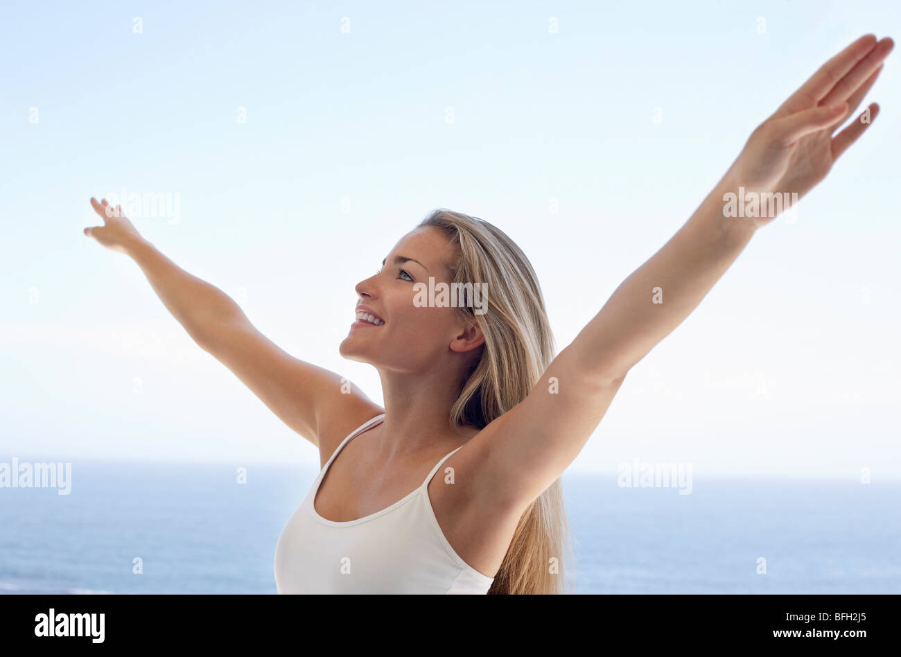 Woman stretching arms over head hi-res stock photography and images - Alamy
