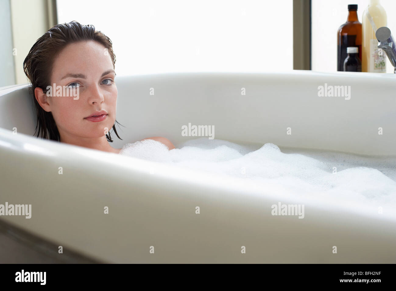 Young woman relaxing in bubble bath Stock Photo Alamy
