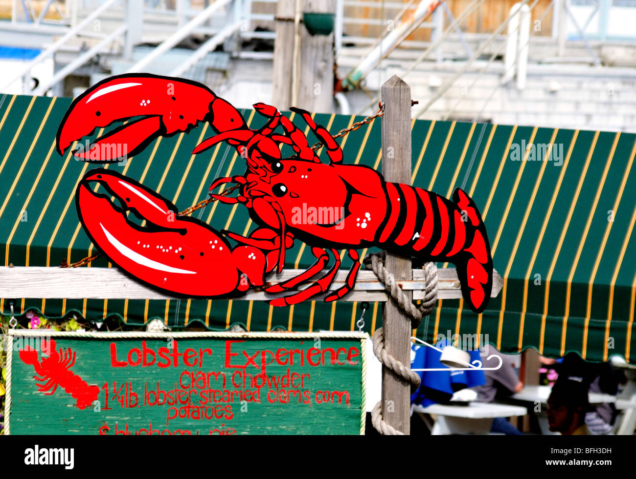 A sign featuring a large, red lobster advertises the menu for a restaurant in Bar Harbor, Maine, USA. Stock Photo