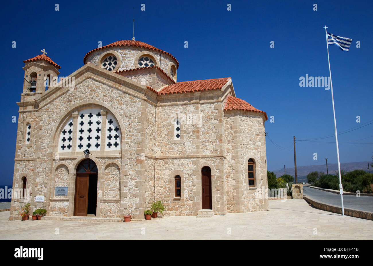 20th century agios georgios church with greek flag flying in st georges bay near pegeias republic of cyprus europe Stock Photo