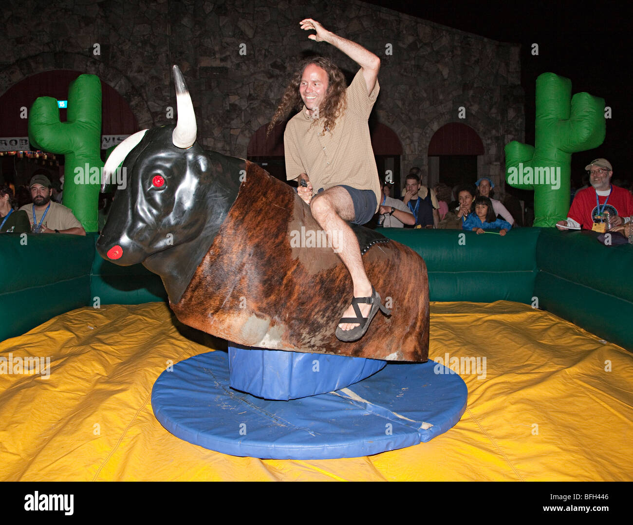 Riding a mechanical bull Texas USA Stock Photo
