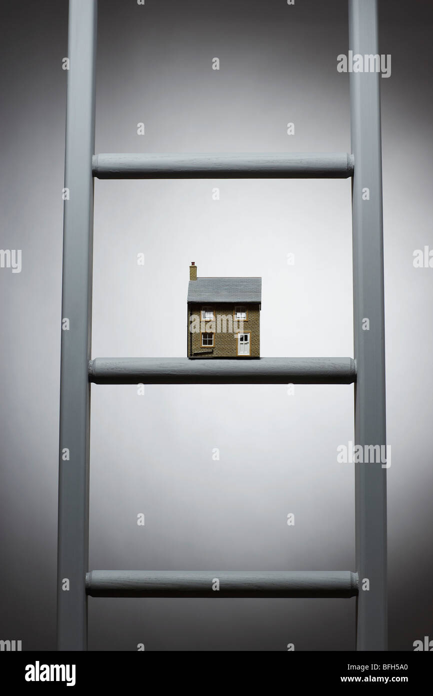 Small model of house on ladder Stock Photo - Alamy