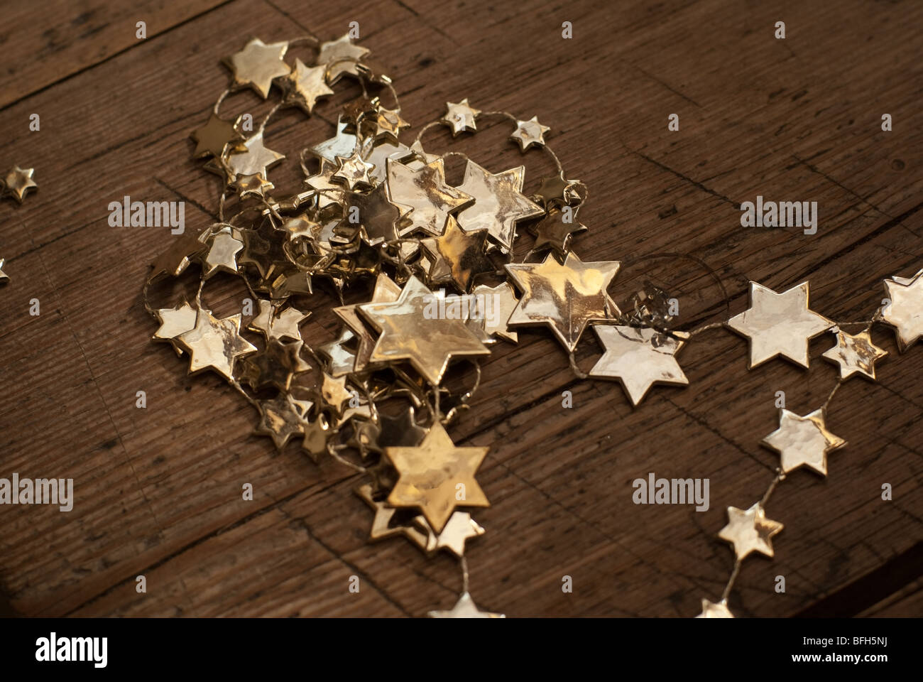 Christmas decorations - golden stars on the wood. Stock Photo