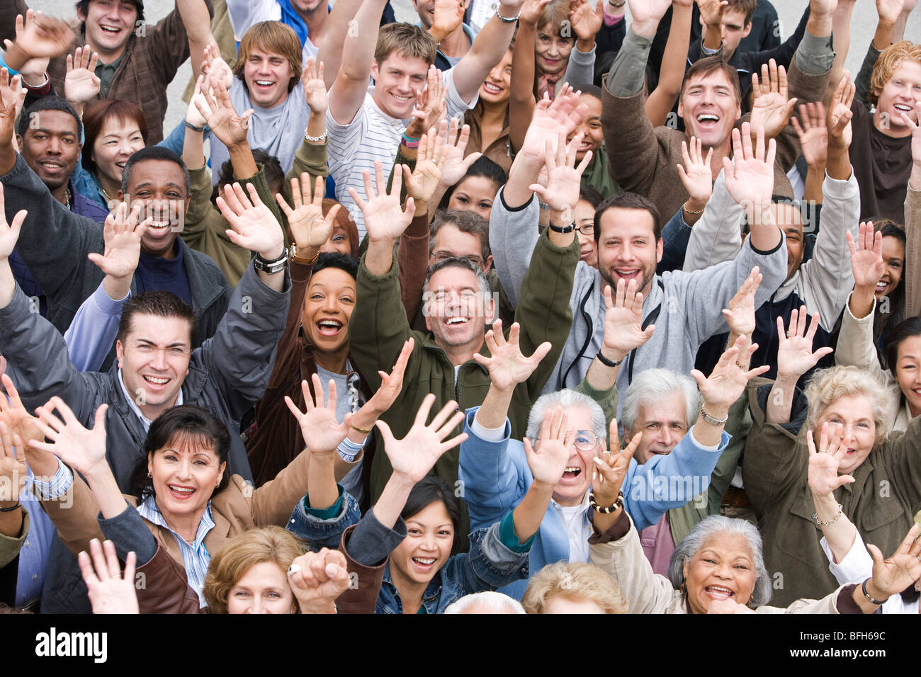 Crowd with arms raised Stock Photo