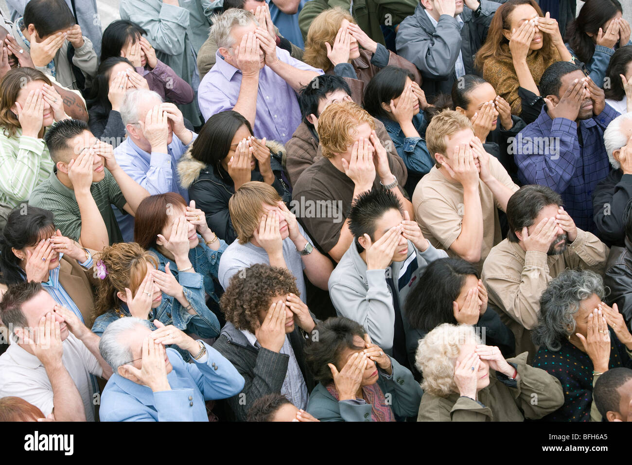 Crowd covering eyes Stock Photo