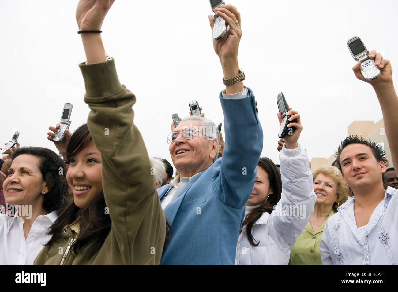 Crowd holding up mobile phones Stock Photo - Alamy