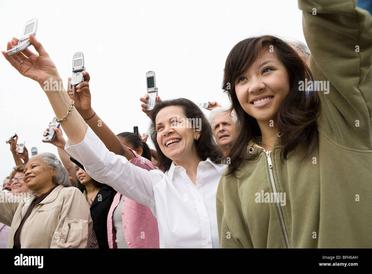 Crowd holding mobile phones hi-res stock photography and images - Alamy