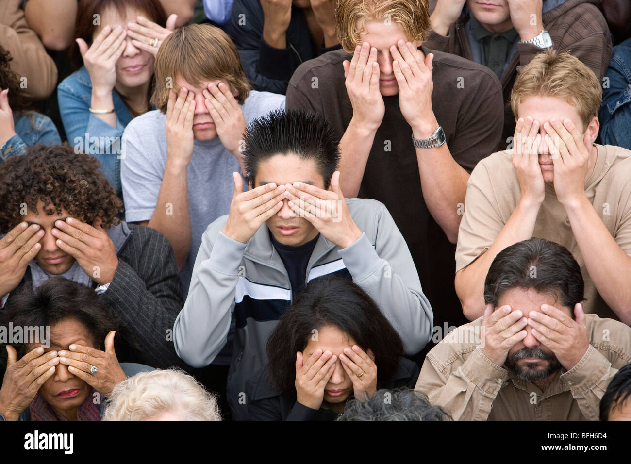 Crowd covering eyes Stock Photo
