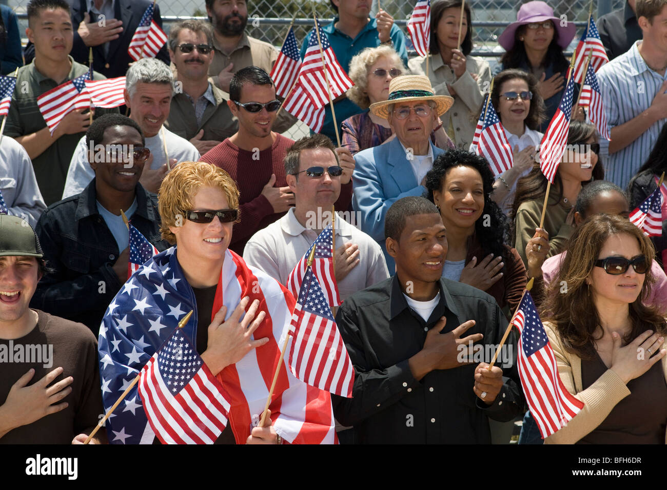 Crowd holding American flags Stock Photo